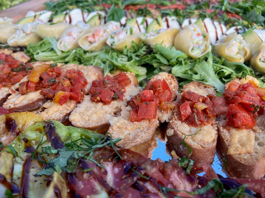 Tomato plate, shells stuffed with seafood, heirloom tomatoes